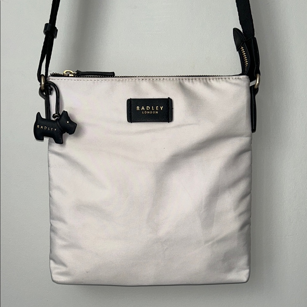 Radley London, grey zip top cross body bag with Dog Charm